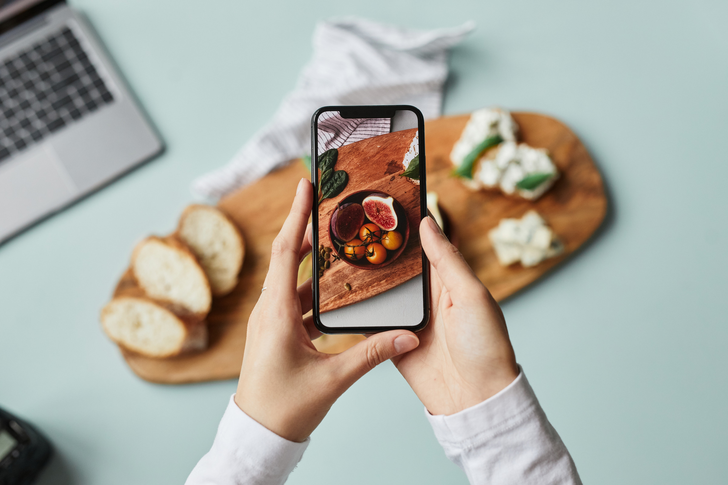 Creator travel setup with food, phone and laptop
