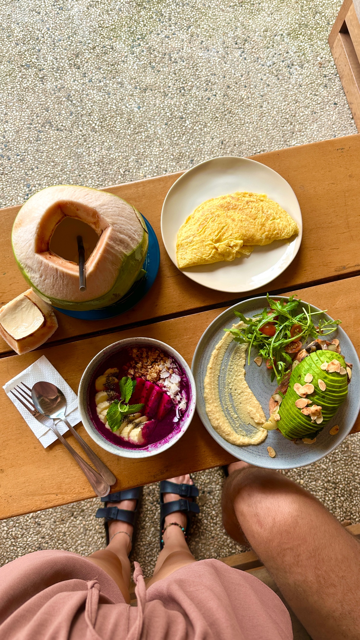 Vegetarian breakfast with coconut, smoothie bowl, hummus and avocado toast