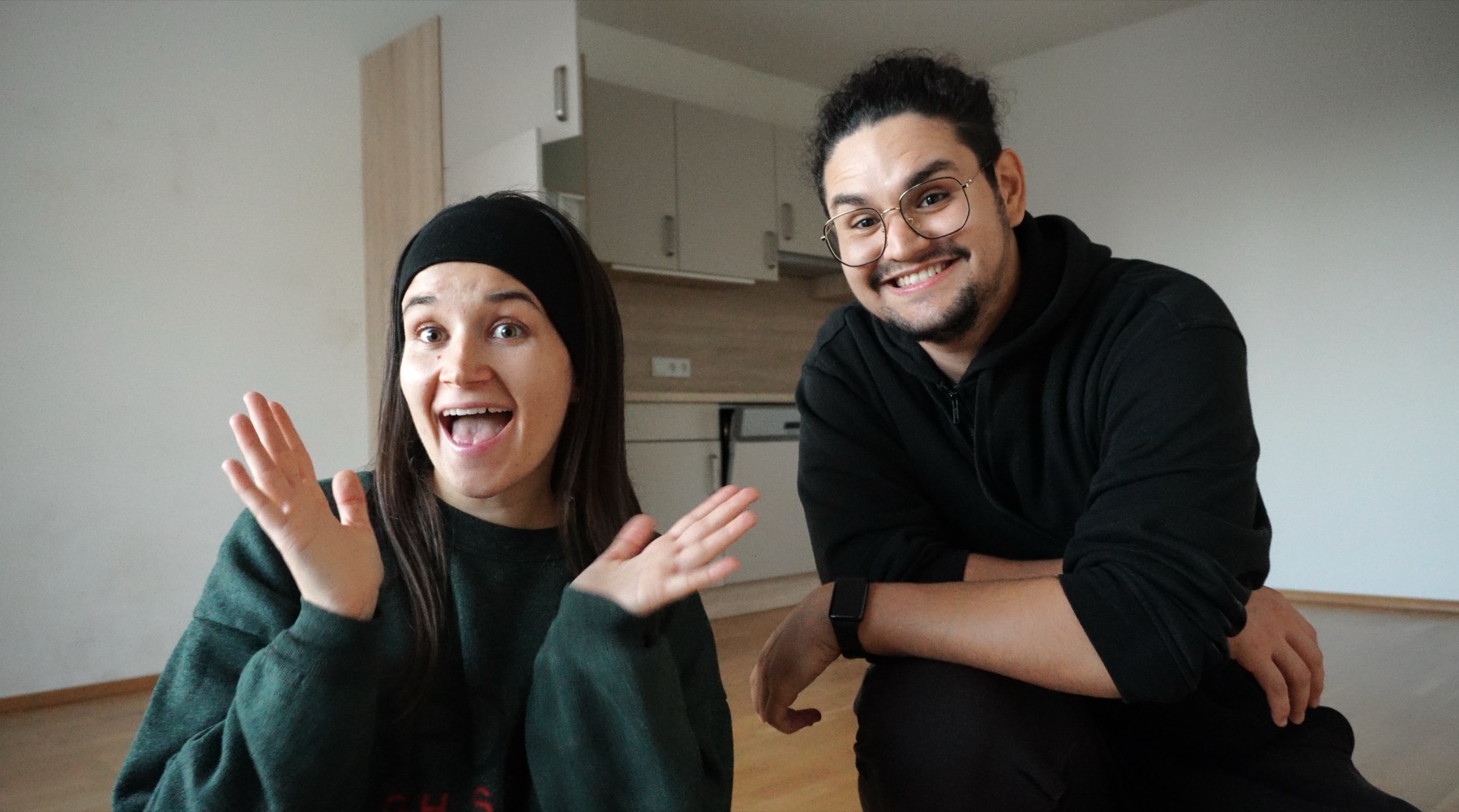 Mina and Res smiling together in their first apartment